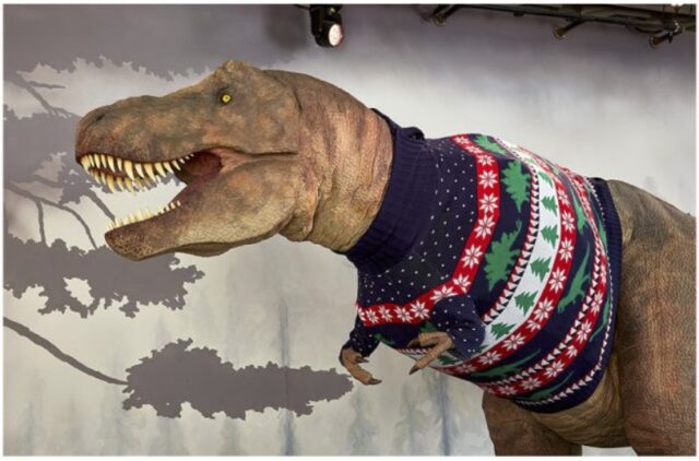 suéter navideño reciclable que viste un Tiranosaurio Rex
